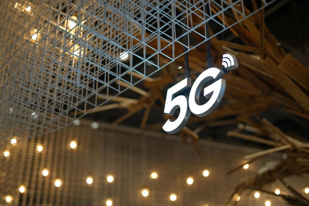 5G network tower with digital signal visualization representing next-generation wireless technology.