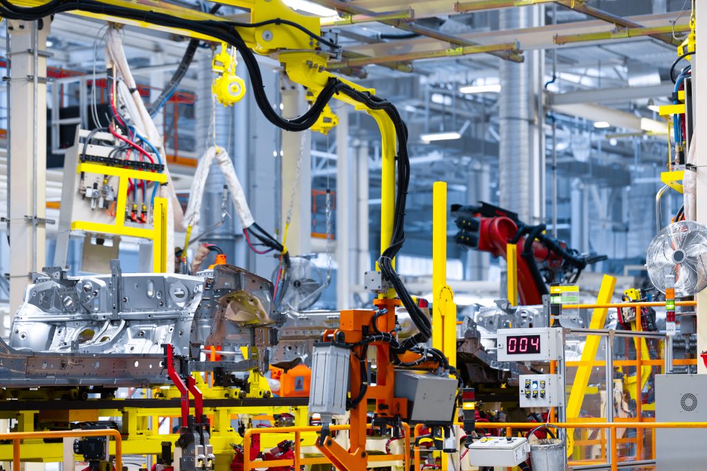 Industrial robotic arms assembling components in a smart factory.